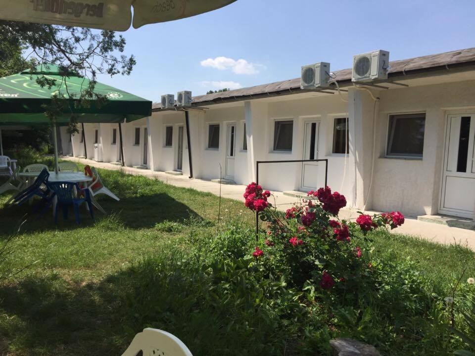 a row of buildings with red flowers in the yard at Bungalow Eforie Nord in Eforie Nord