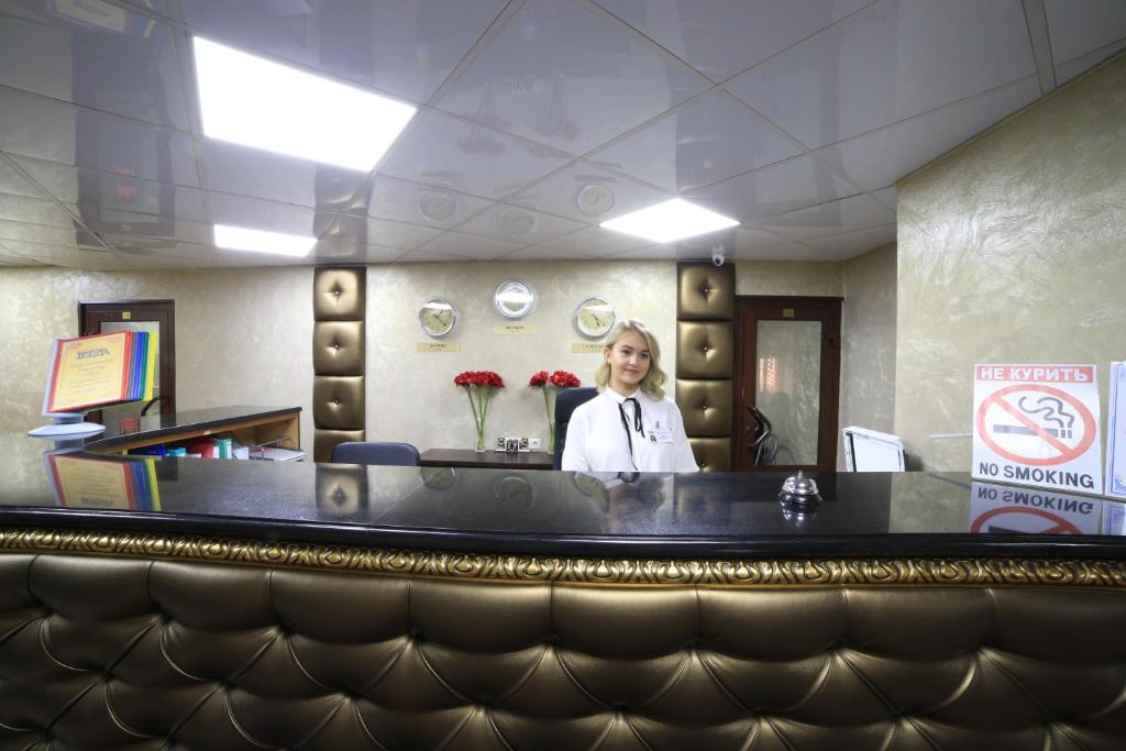 a woman standing behind the counter of a restaurant at Gerda in Mytishchi