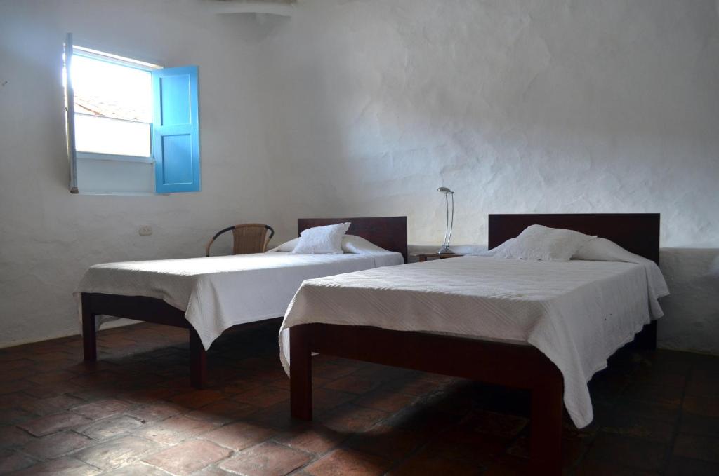 A bed or beds in a room at Albahaca Hospedaje Tienda