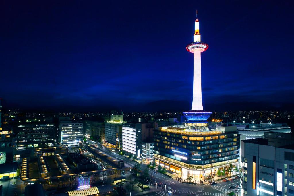 a view of a city at night with a tower at Kyoto Tower Hotel in Kyoto