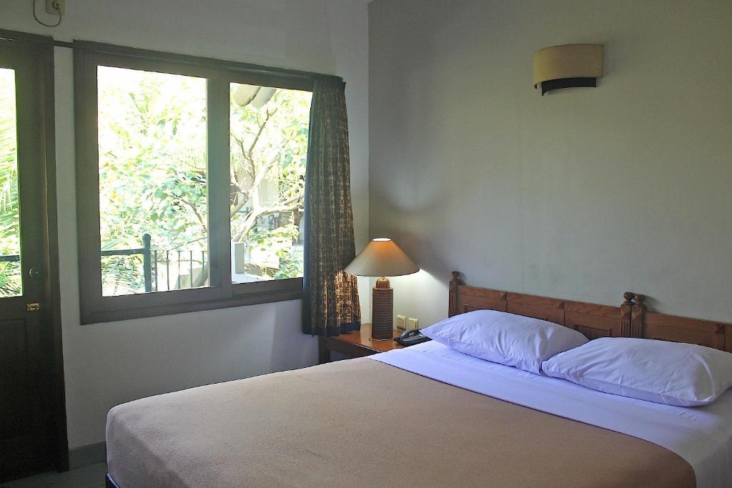 Postel nebo postele na pokoji v ubytování Hotel Winotosastro Garden
