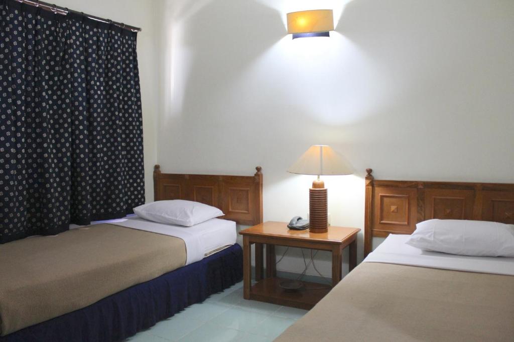 Postel nebo postele na pokoji v ubytování Hotel Winotosastro Garden