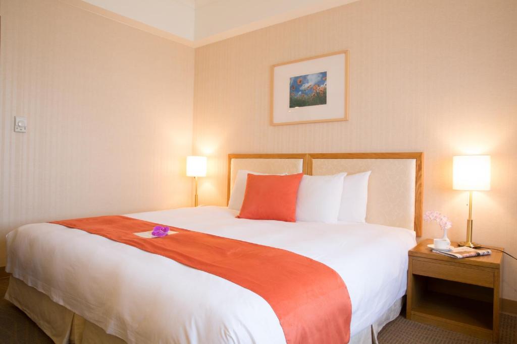Postel nebo postele na pokoji v ubytování Hotel Riverview Taipei