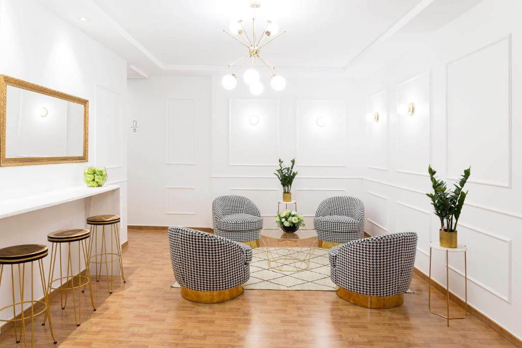 een kamer met stoelen, een tafel en een spiegel bij Hostal Oriente in Madrid