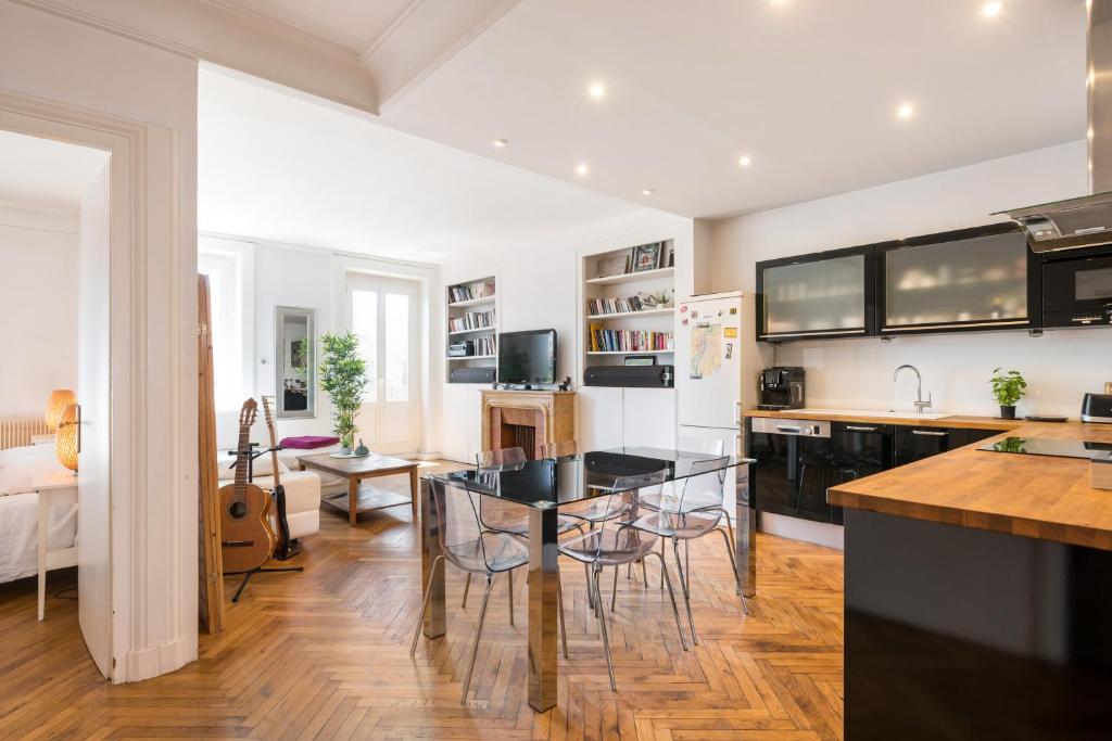 a kitchen and living room with a table and chairs at Saxe And The City , Downtown Lyon in Lyon