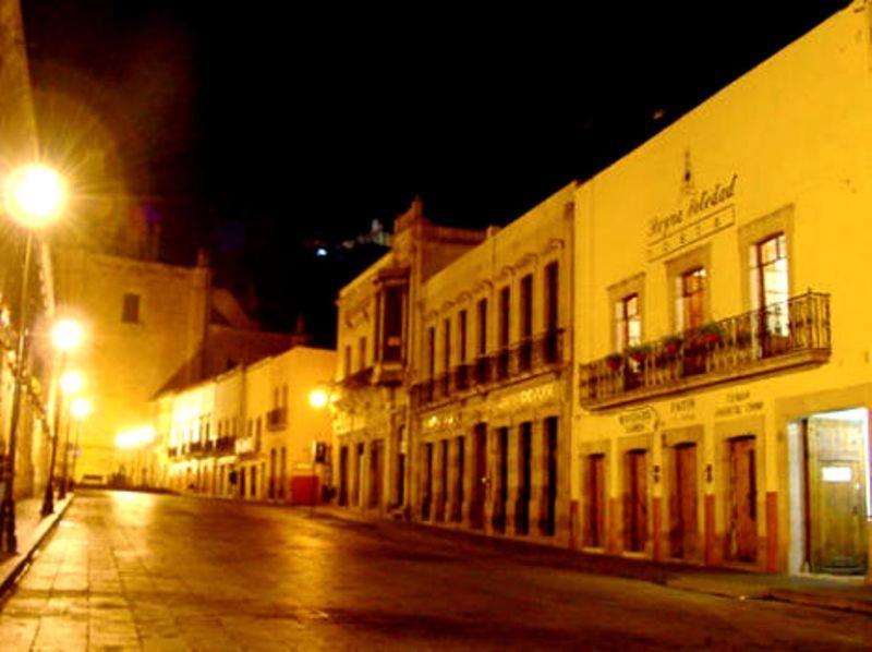an empty city street at night with buildings at Hotel Reyna Soledad in Zacatecas