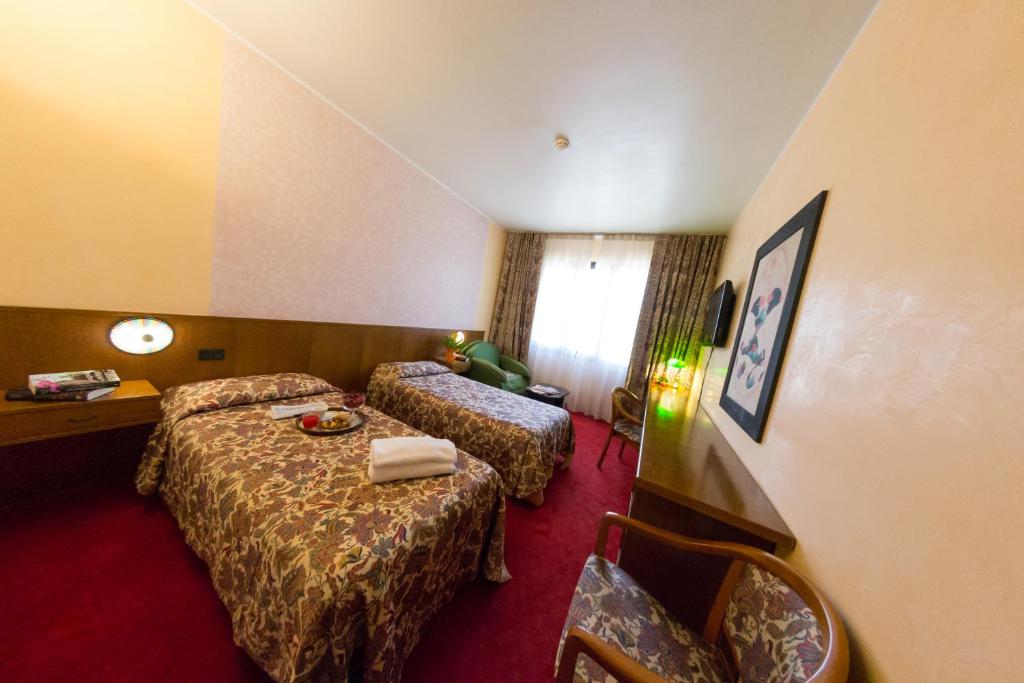 Posteľ alebo postele v izbe v ubytovaní Hotel Tessarin
