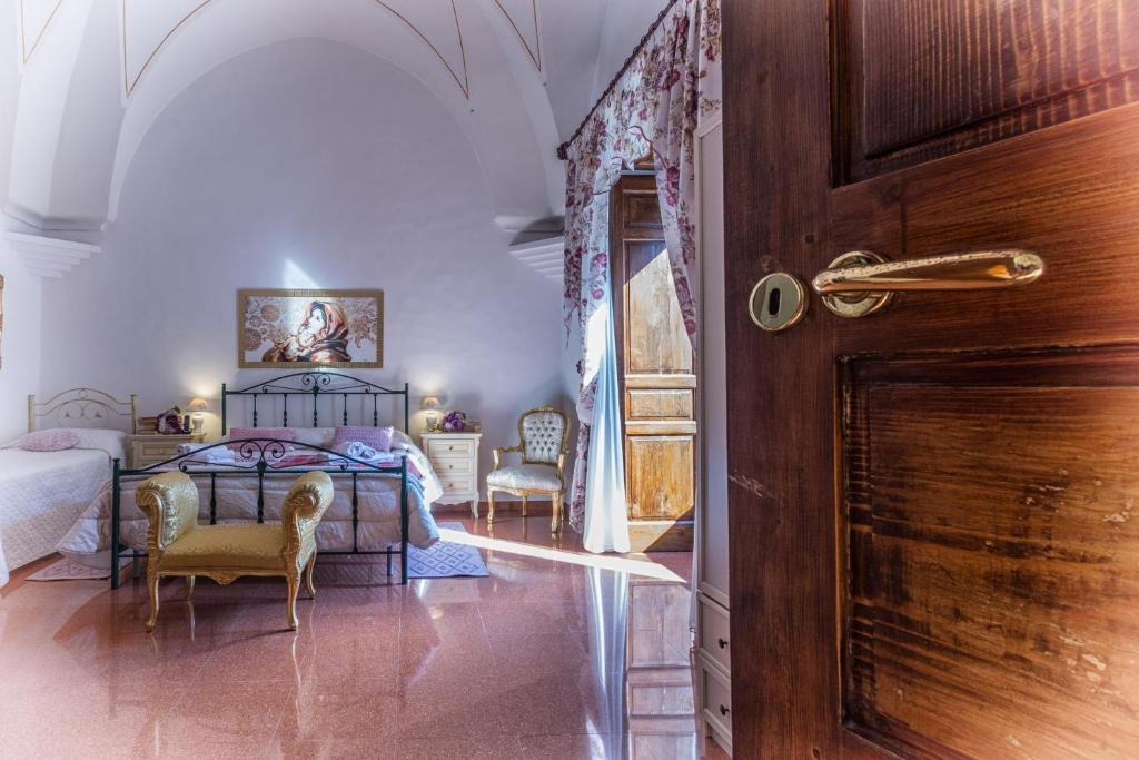a bedroom with a bed and a table and chairs at Palazzotto in Ostuni