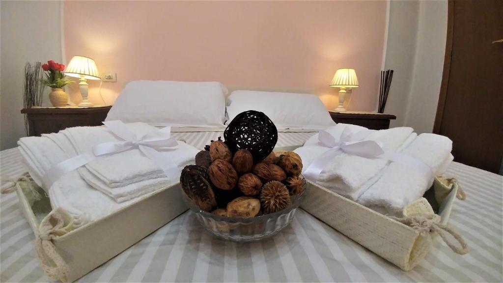 a bedroom with a bed with towels and a bowl of nuts at Dreaming Navona Rooms in Rome