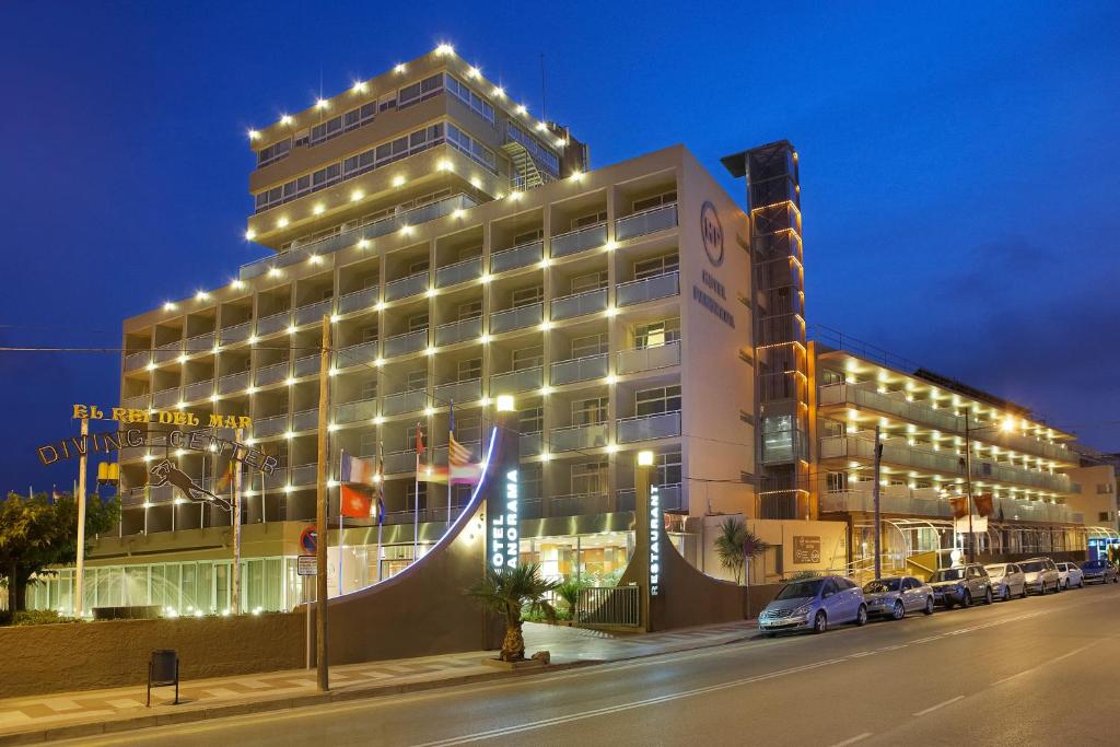 a building with lights on the side of a street at Hotel Panorama in L'Estartit