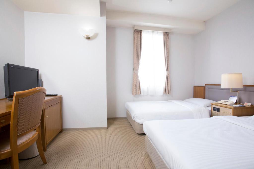 Postel nebo postele na pokoji v ubytování Tetoranze Makuhari Inagekaigan Hotel