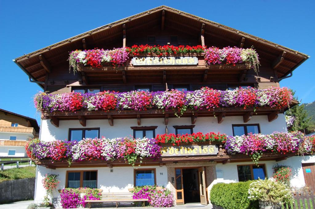 a building with lots of flower boxes on it at Gästehaus Edelweiss in Reith bei Seefeld