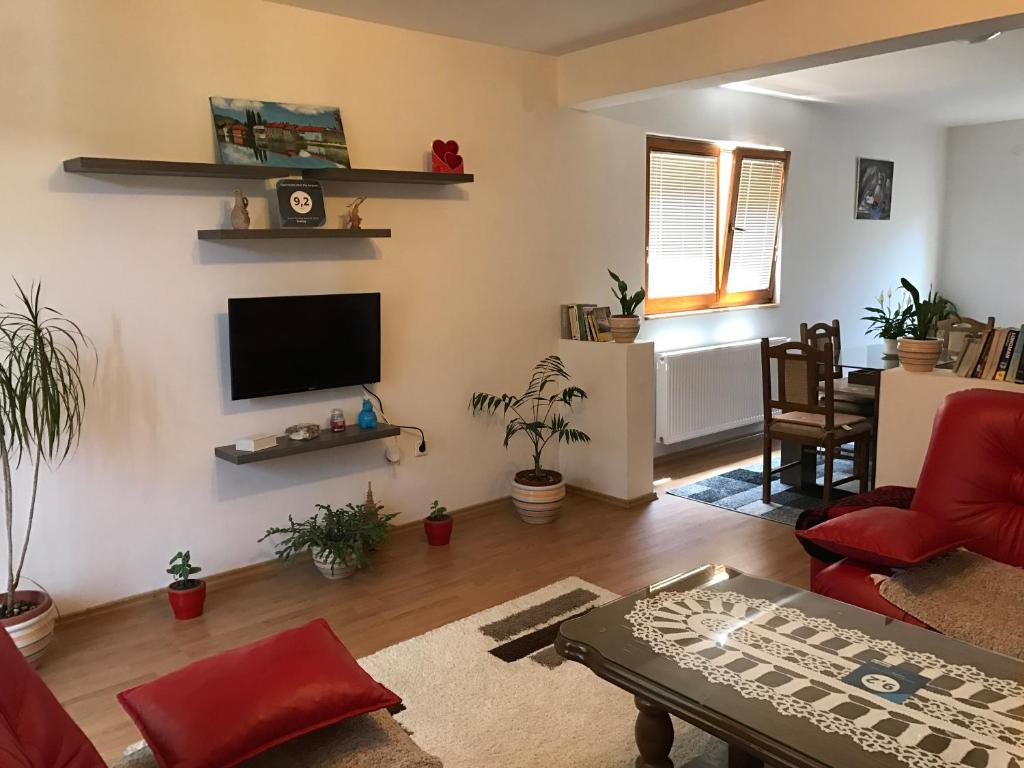 a living room with a flat screen tv on a wall at Apartment near the Airport in Sarajevo