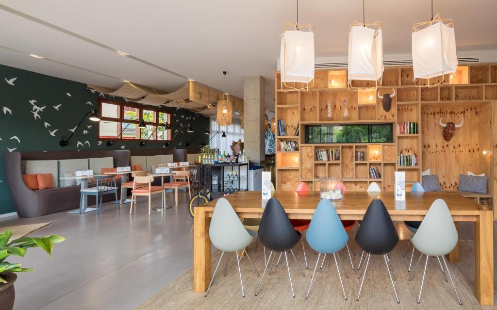 a restaurant with a large wooden table and chairs at AQUA Hotel Bertran Park in Lloret de Mar