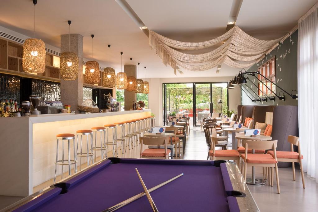 a pool table in a restaurant with a bar at AQUA Hotel Bertran Park in Lloret de Mar