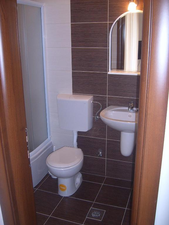 a bathroom with a toilet and a sink at Apartmani Kovačević in Kotor