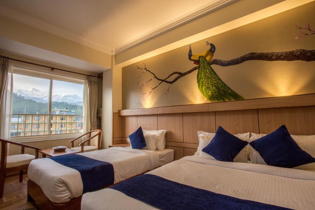 Rúm í herbergi á Hotel White Pearl