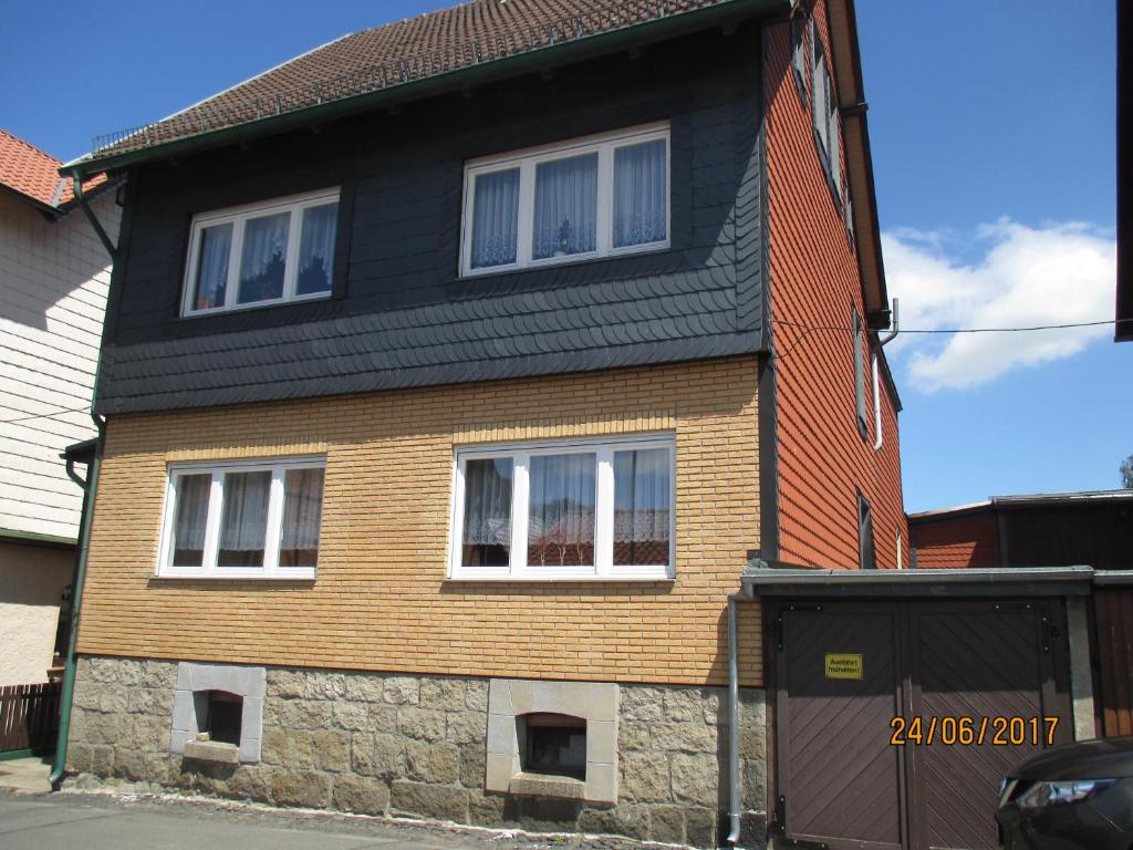 a house with a black roof and white windows at Ferienwohnung Mack in Wernigerode