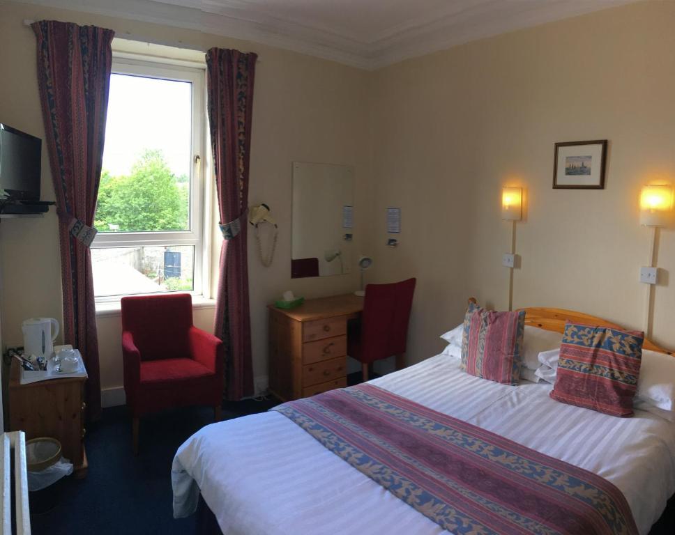 a hotel room with a bed and a window at Arkaig Guest House in Aberdeen