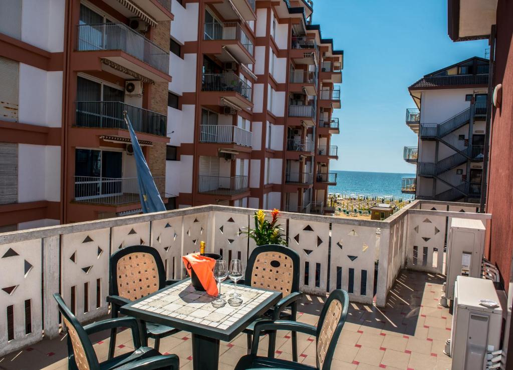 a table and chairs on a balcony with a view of the ocean at Hotel Malibran in Lido di Jesolo