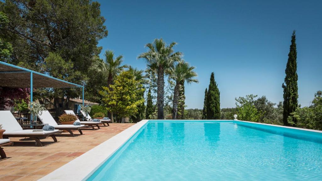 a swimming pool with lounge chairs and trees at Finca Son Miranda - LA Organic in Sencelles