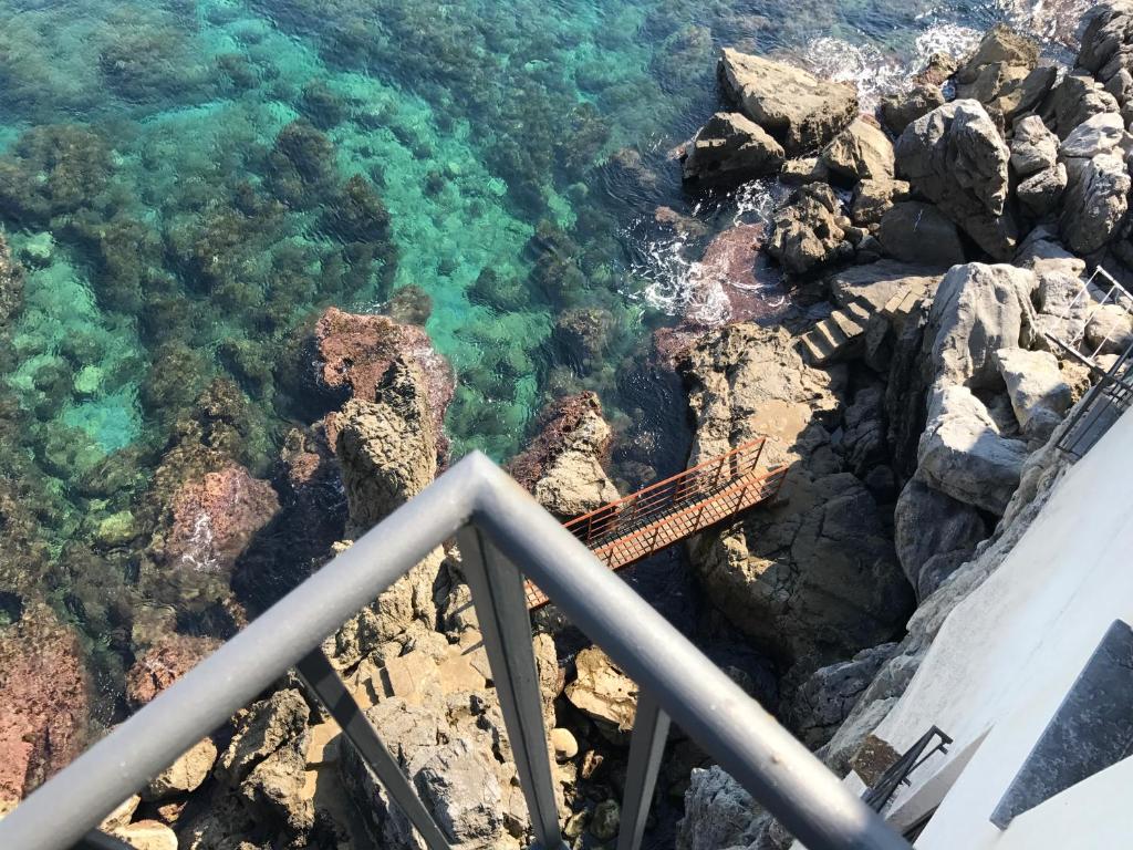 a bridge on the rocks near the ocean at Casalmare in Cefalù