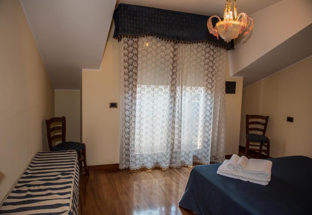 Postel nebo postele na pokoji v ubytování Hotel Malibran