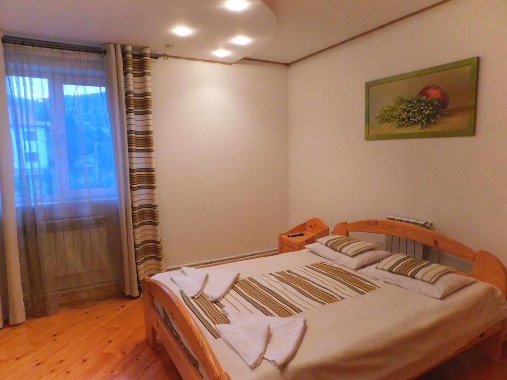 a bedroom with a bed in a room with a window at Glanz in Yaremche