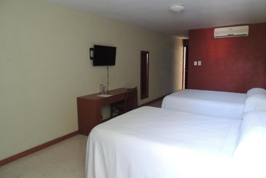 Postel nebo postele na pokoji v ubytování Hotel Central