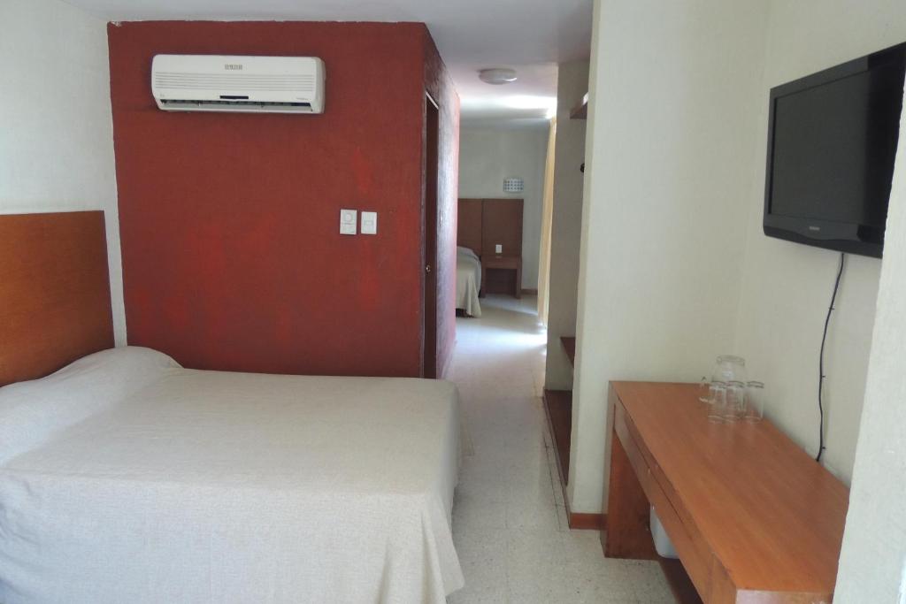 Postel nebo postele na pokoji v ubytování Hotel Central