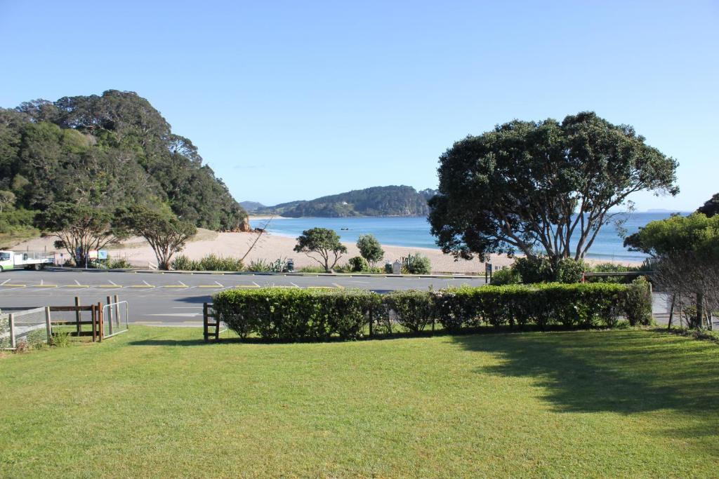 a park with a view of the beach and a parking lot at Hot Water Beach Cottage in Hotwater Beach