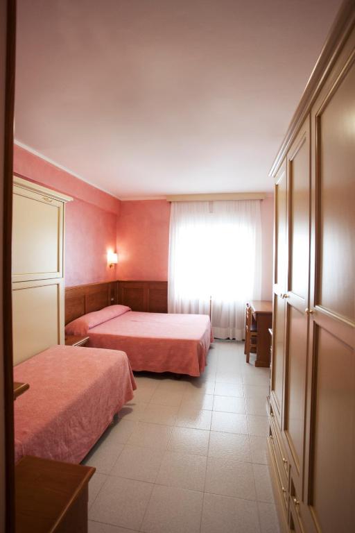 Postel nebo postele na pokoji v ubytování Hotel Sporting