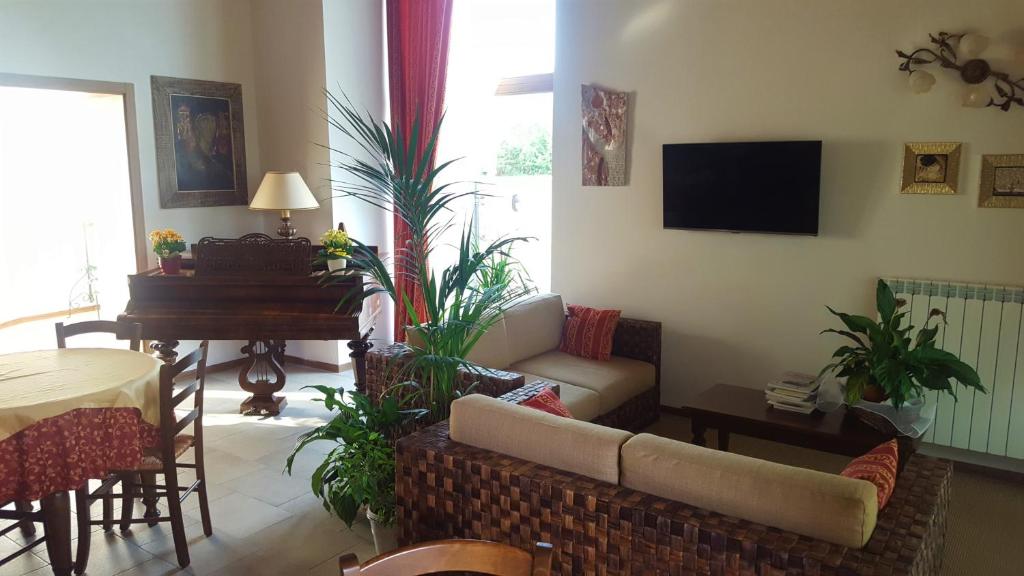 a living room with a couch and a piano at Agriturismo Gradec in Aurisina