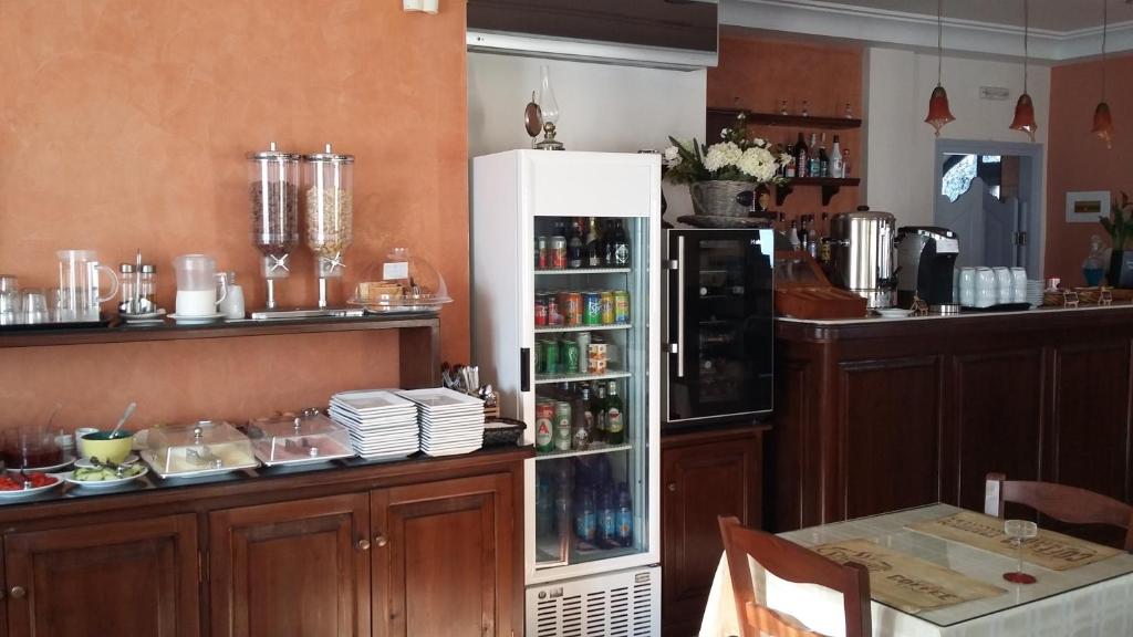 a kitchen with a counter with a refrigerator at Anemoessa Villa in Oia