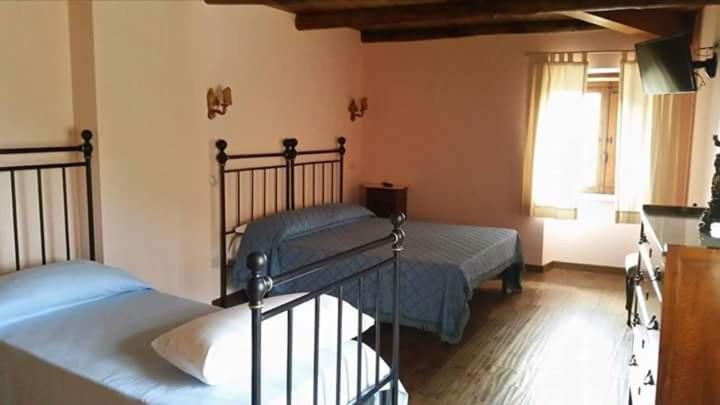 Postel nebo postele na pokoji v ubytování Hotel Albergo Ristorante Il Ciclope