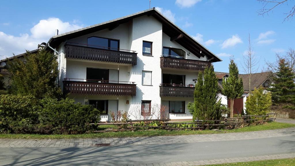 a white house with balconies on the side of it at Winterberg-Hasewinkel in Winterberg