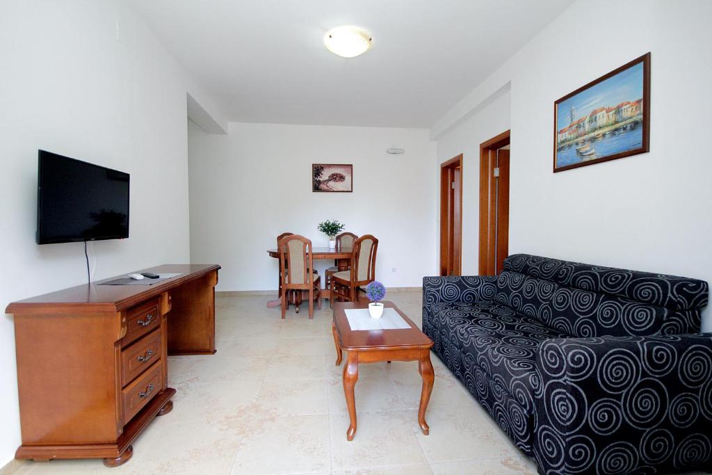 a living room with a couch and a table at Apartmani More in Sveti Stefan