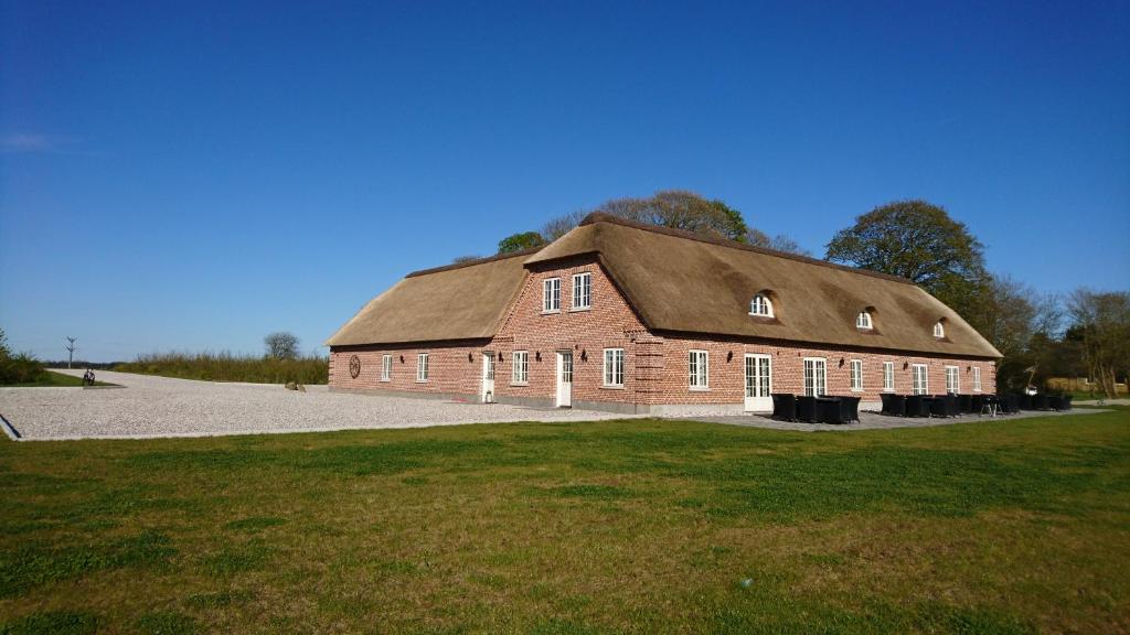 a large red brick building with a gambrel roof at Aagaarden in Billund