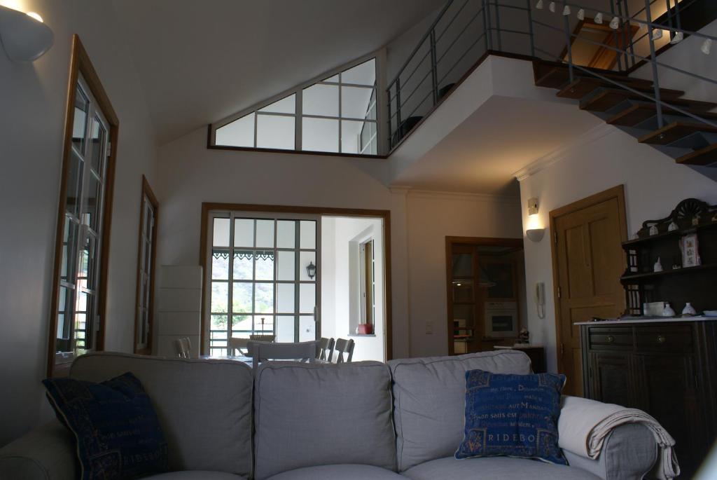 a living room with a couch with blue pillows at Loft Paços da Vila in Ribeira Brava