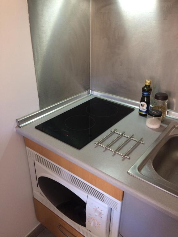 a kitchen with a stove and a sink at Ericeira Surf and Sun in Ericeira