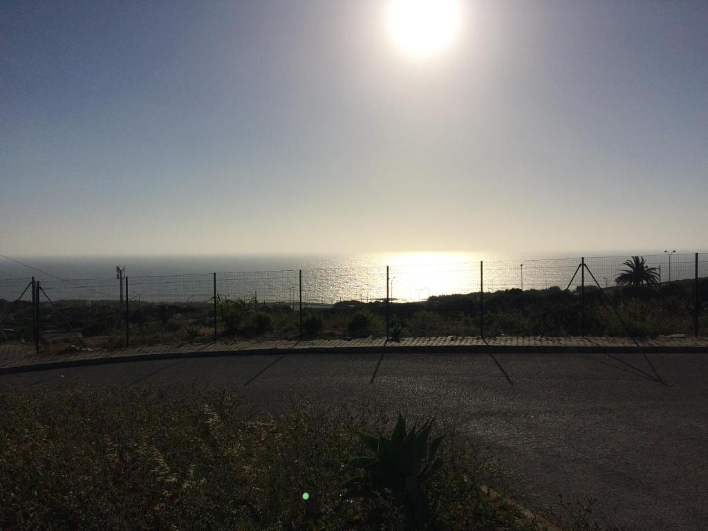 a view of the ocean from a road at Ericeira Surf and Sun in Ericeira