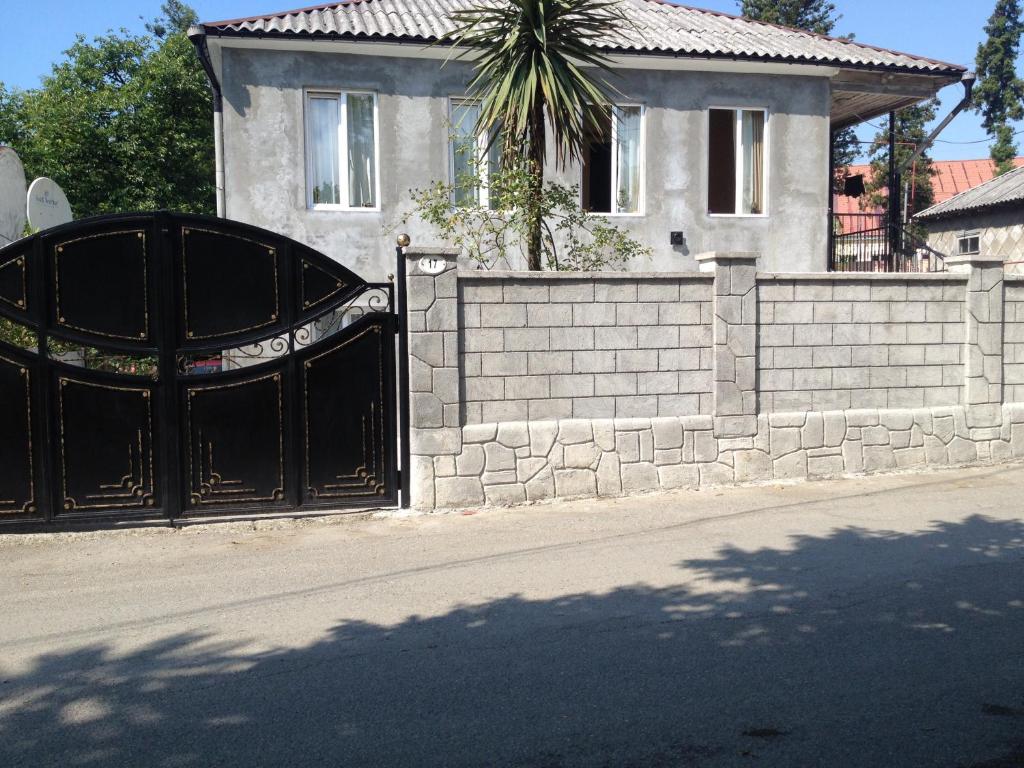 a black gate in front of a house at Guest House Maxim in Makhinjauri