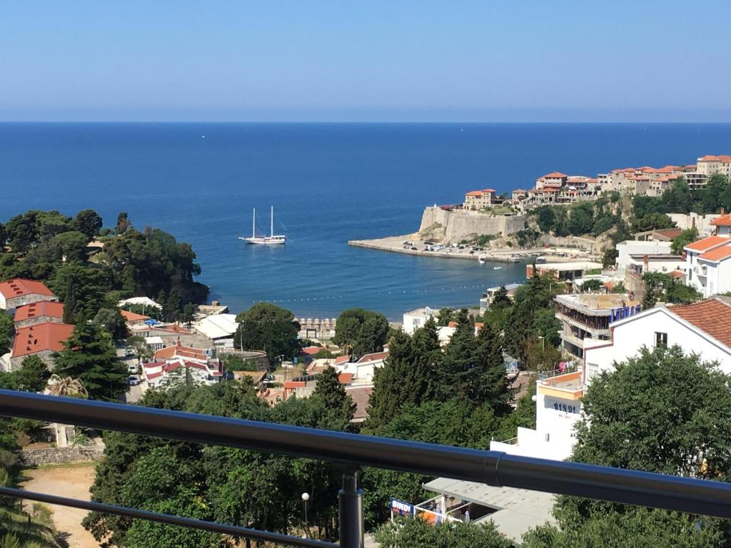 a view of a city with a boat in the water at Apartments Panorama Alaj in Ulcinj