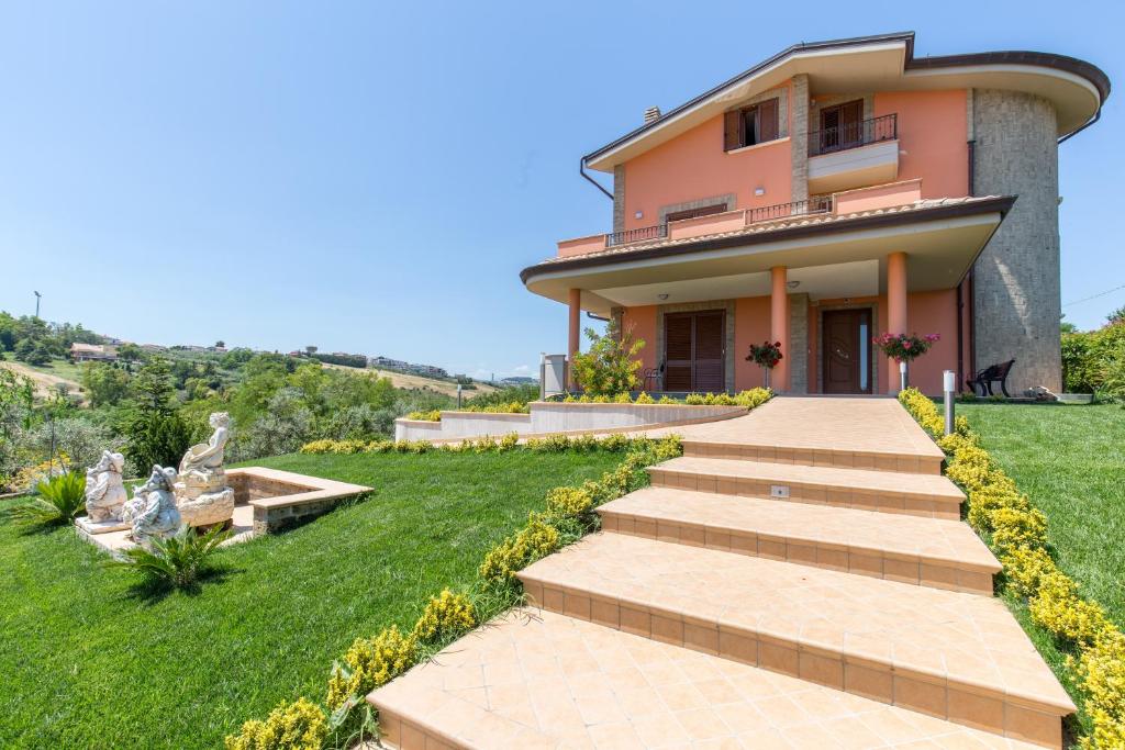 a villa with a staircase leading to a house at B&B Paradiso in San Salvo