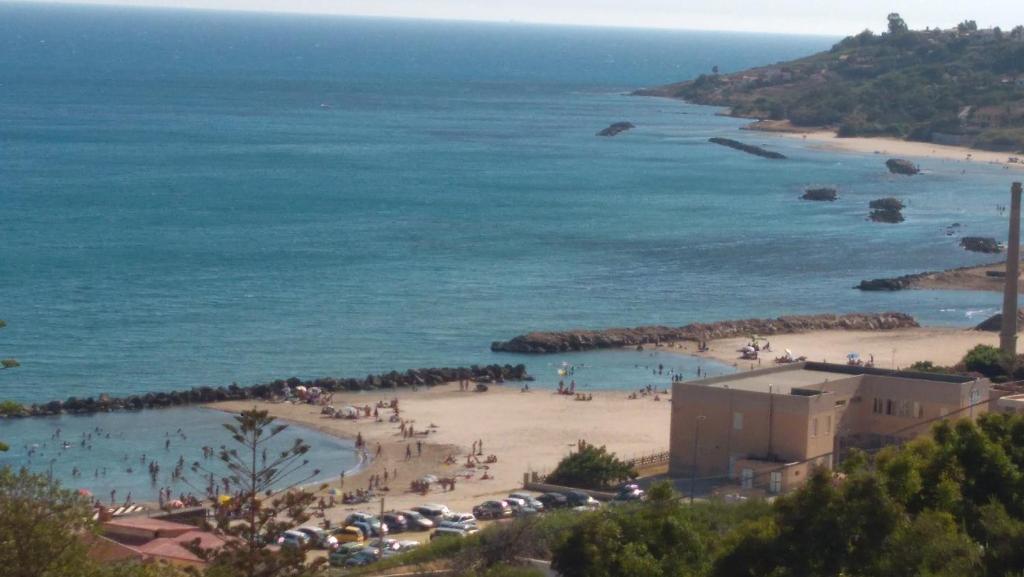 a beach with a group of people and cars at Villa Margherita in Sciacca