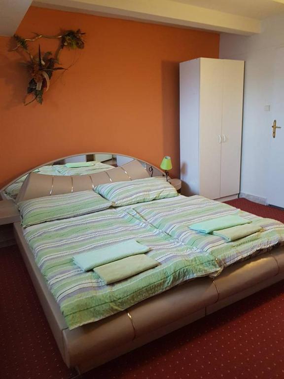 A bed or beds in a room at Penzión KORMOŠ