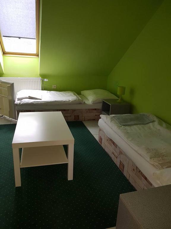 A bed or beds in a room at Penzión KORMOŠ
