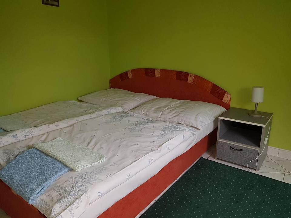 A bed or beds in a room at Penzión KORMOŠ