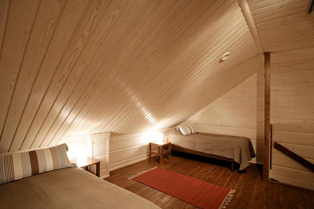 Кровать или кровати в номере Ounasvaaran Lakituvat Chalets