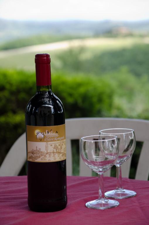 a bottle of wine sitting next to a wine glass at Podere Remignoli in San Gimignano